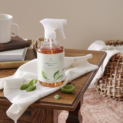Thymes Fresh Cut Basil Wood Cleaning Spray on table
